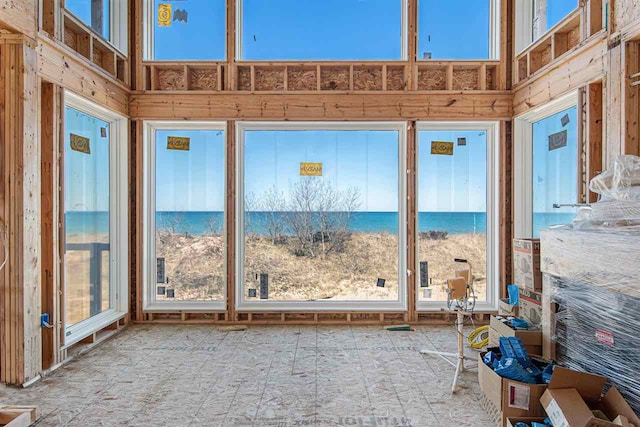 unfurnished sunroom with a water view