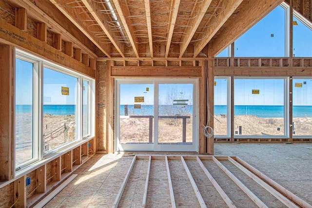 unfurnished sunroom with a water view