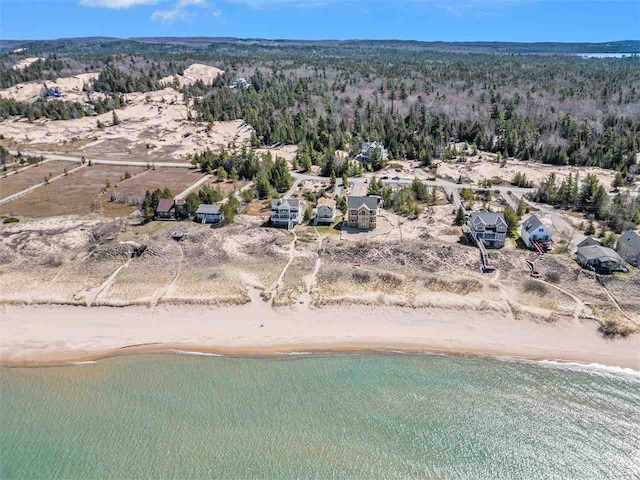 drone / aerial view with a beach view and a water view