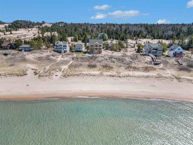 drone / aerial view featuring a beach view and a water view