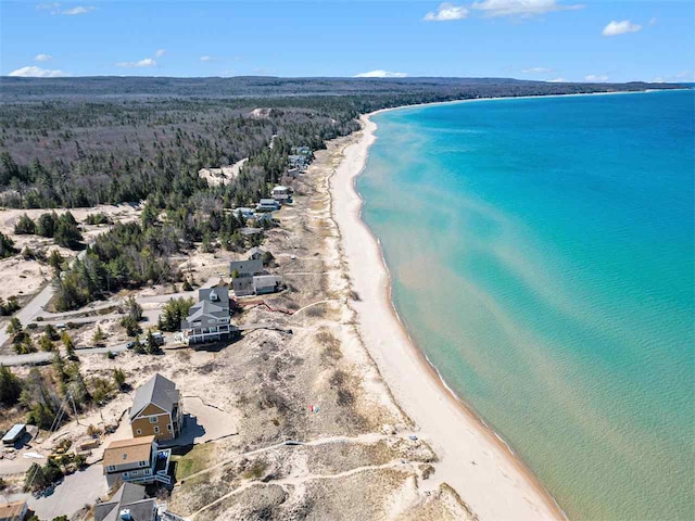 birds eye view of property featuring a beach view and a water view