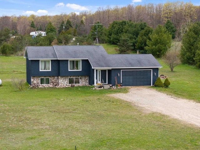 view of front of house featuring a garage and a front lawn