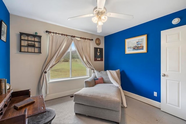 sitting room featuring tile floors and ceiling fan