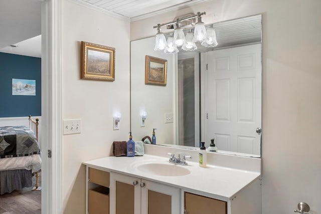 bathroom with hardwood / wood-style flooring, crown molding, and oversized vanity