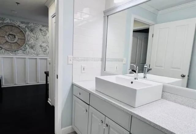 bathroom with ornamental molding and vanity