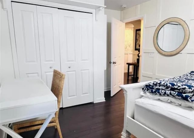 bedroom featuring dark hardwood / wood-style flooring and a closet