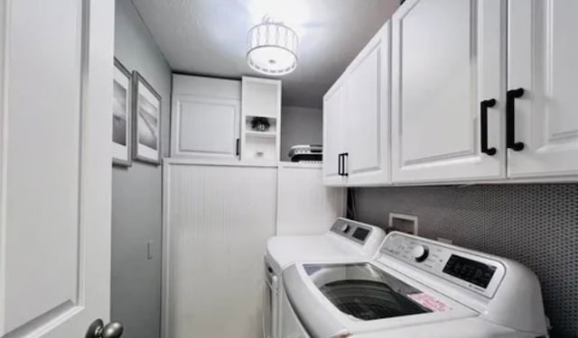 laundry room featuring cabinets, washer hookup, and washing machine and clothes dryer