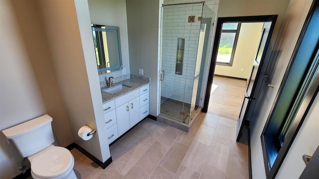 bathroom with vanity, an enclosed shower, tile patterned flooring, and toilet