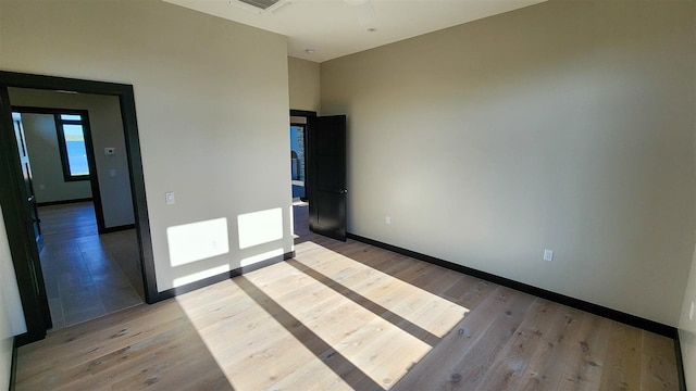 unfurnished room featuring hardwood / wood-style floors and ceiling fan