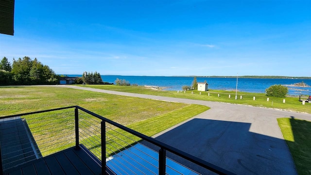 exterior space featuring a water view and a lawn