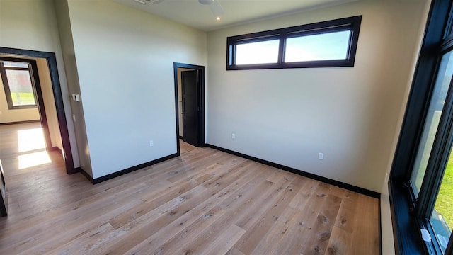 empty room with light hardwood / wood-style flooring and ceiling fan