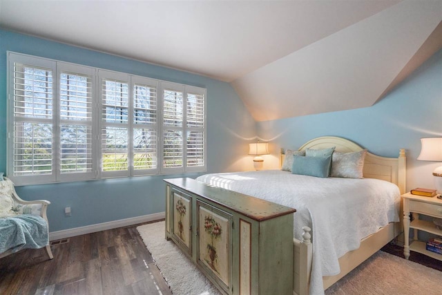 bedroom with dark hardwood / wood-style flooring and lofted ceiling