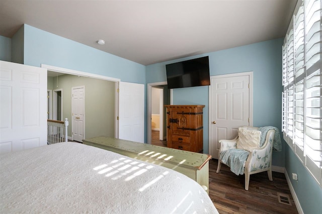 bedroom with dark hardwood / wood-style floors