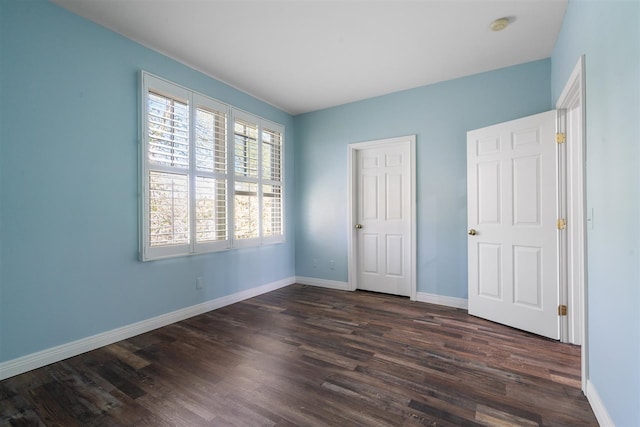 unfurnished bedroom with dark wood-type flooring