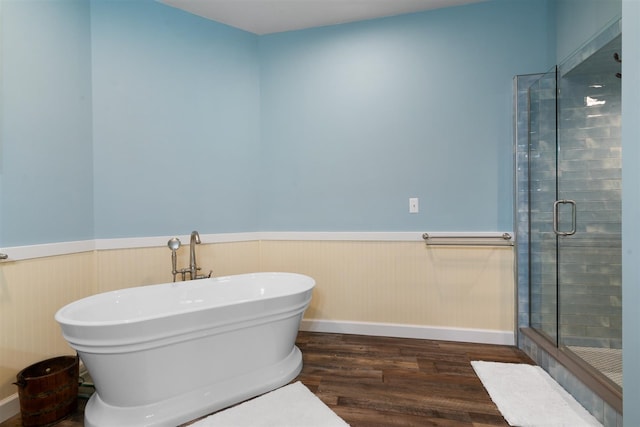 bathroom with a shower with shower door and wood-type flooring