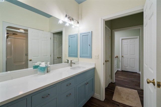 bathroom with wood-type flooring and oversized vanity