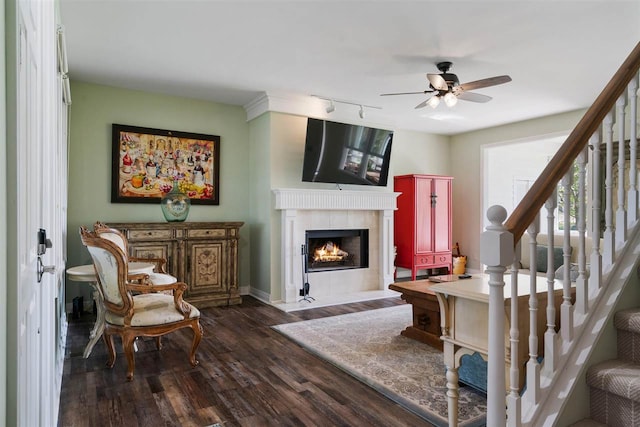 living room with ceiling fan, dark hardwood / wood-style flooring, a fireplace, and track lighting