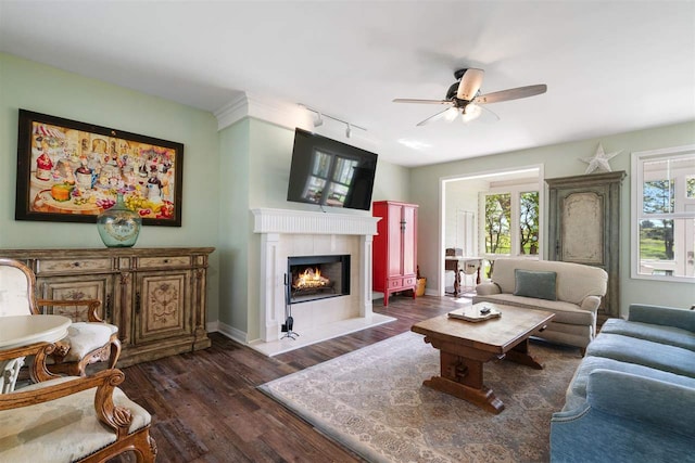 living room with dark hardwood / wood-style floors, plenty of natural light, and ceiling fan