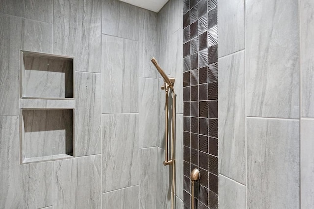 bathroom with tiled shower