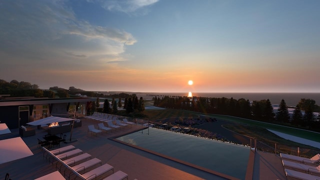 pool at dusk featuring a patio area