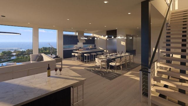 interior space with light wood-type flooring and a water view