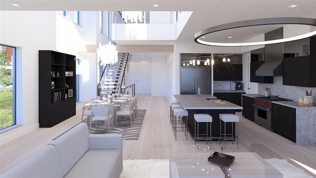 living room featuring a high ceiling, sink, and a skylight