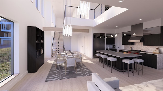 interior space featuring a high ceiling, light wood-type flooring, and a chandelier