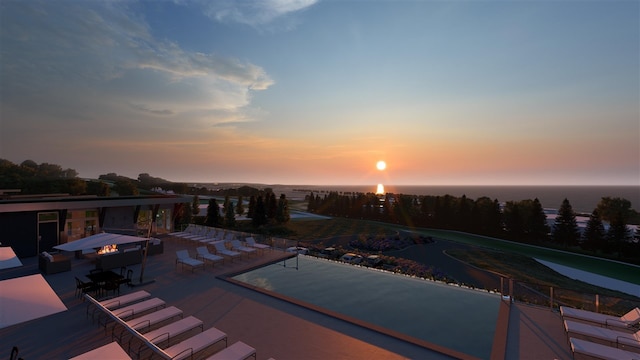 pool at dusk with a patio