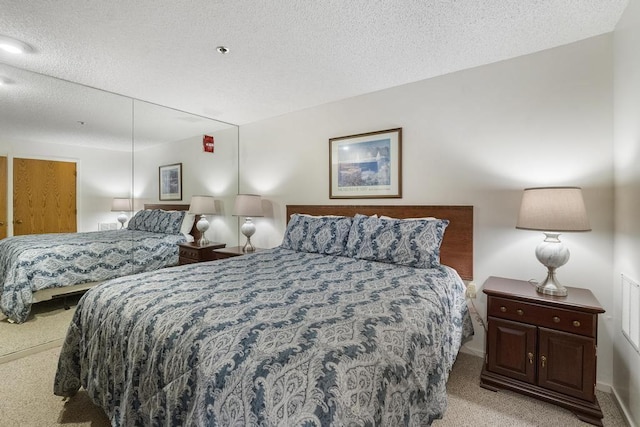 carpeted bedroom with a textured ceiling