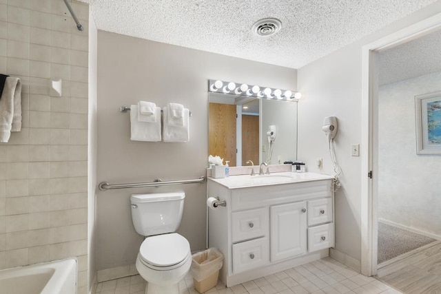 full bathroom with vanity, a textured ceiling, toilet, and tile patterned flooring