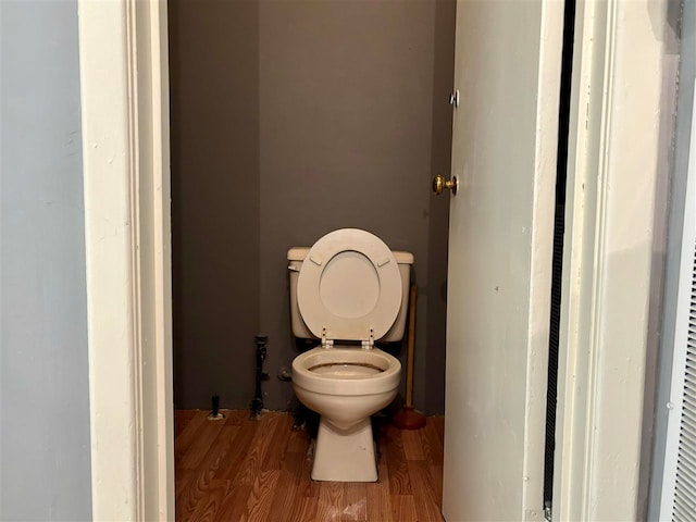 bathroom featuring toilet and wood-type flooring