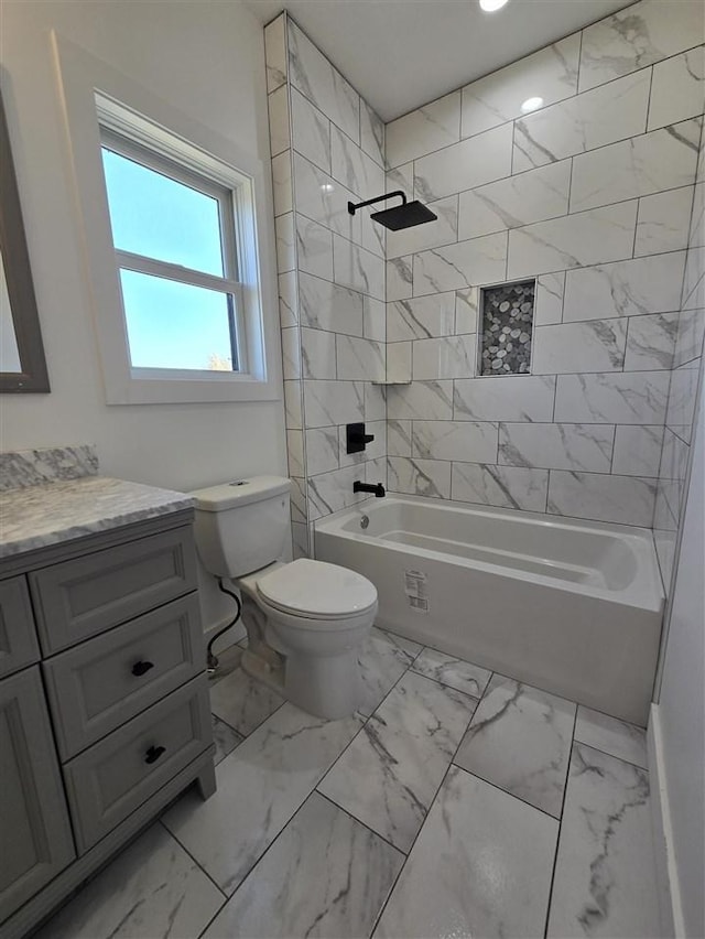 full bathroom featuring vanity, toilet, and tiled shower / bath