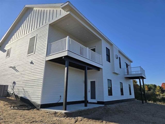 exterior space featuring a patio area, a balcony, and central air condition unit