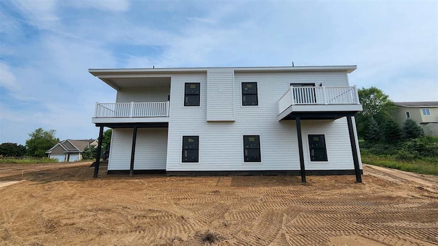 back of house featuring a balcony