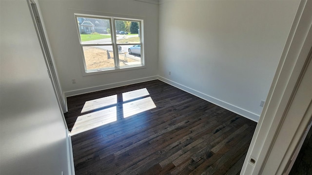 empty room featuring dark hardwood / wood-style flooring