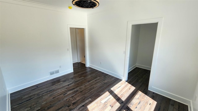 unfurnished room featuring dark hardwood / wood-style floors and ornamental molding