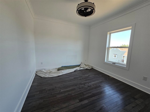 unfurnished room with dark wood-type flooring and ornamental molding