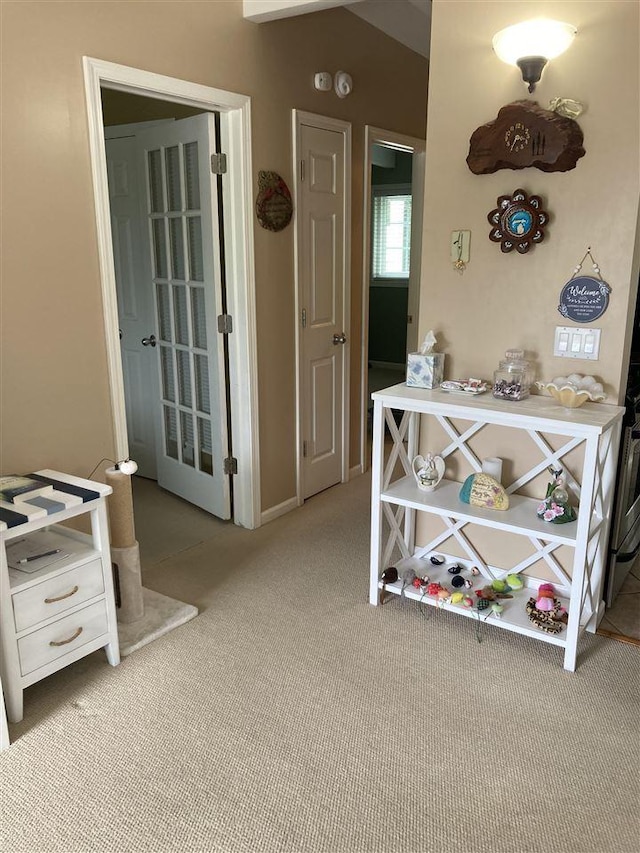 hallway with light colored carpet