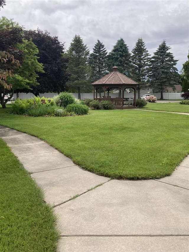 view of property's community with a gazebo and a yard