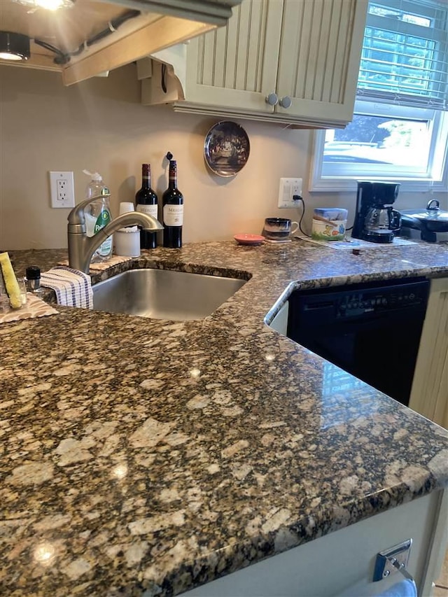 kitchen featuring sink and black dishwasher