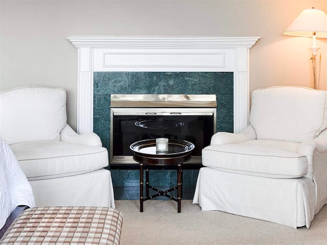 living area featuring carpet flooring and a tiled fireplace