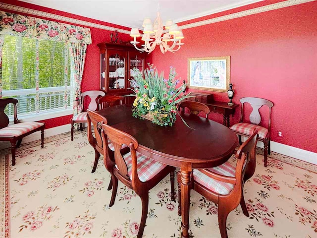 dining area featuring a healthy amount of sunlight, ornamental molding, and an inviting chandelier