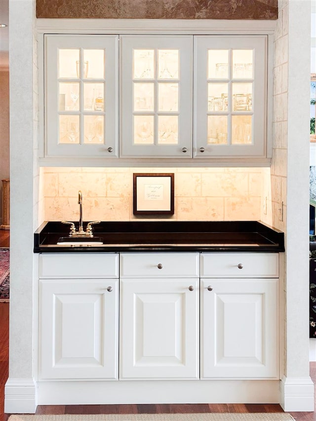 kitchen with white cabinets, sink, and plenty of natural light