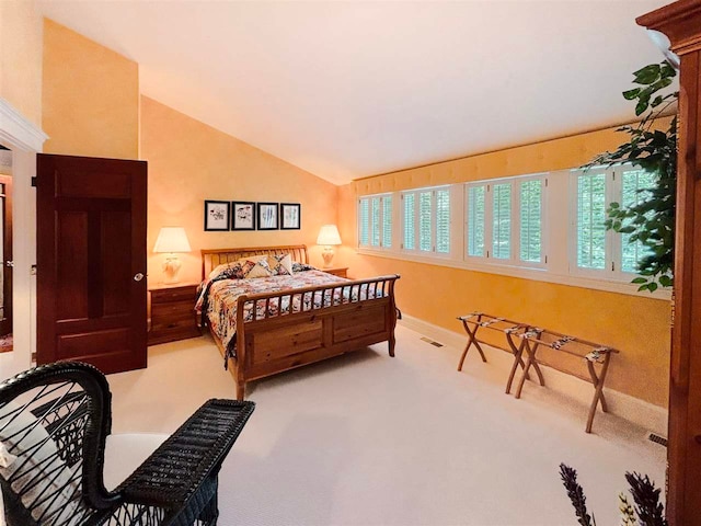 bedroom featuring lofted ceiling, visible vents, carpet floors, and baseboards