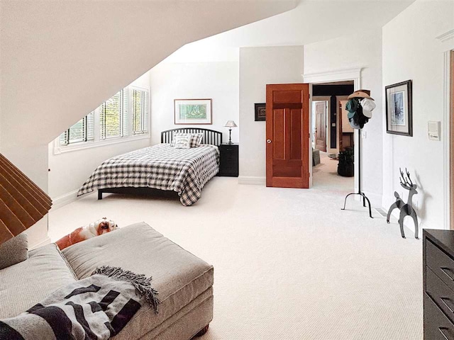 bedroom with carpet floors and vaulted ceiling