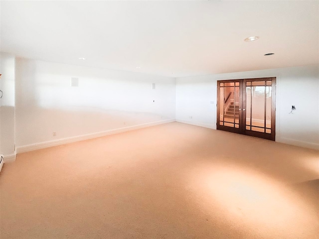 empty room with french doors and carpet flooring