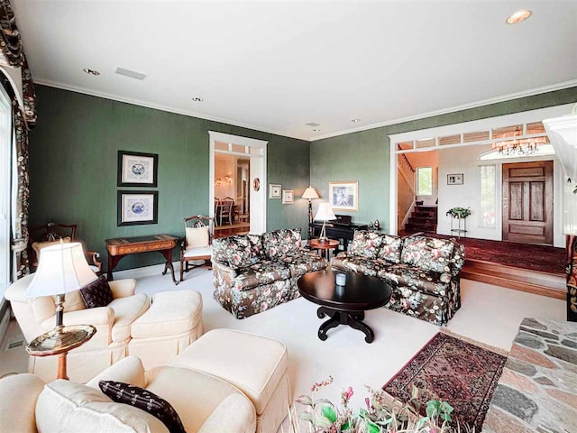 living area with visible vents, stairway, and ornamental molding