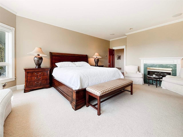 bedroom with ornamental molding, carpet flooring, and a tile fireplace