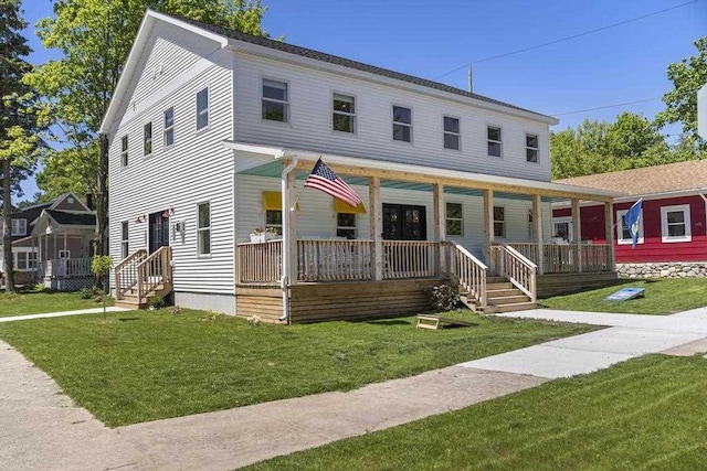 401 Antrim St, Charlevoix, MI 49720 - view of front facade featuring covered porch and a front lawn