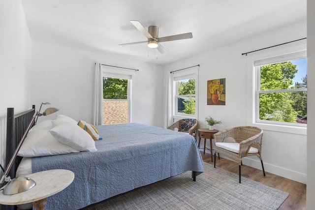 401 Antrim St, Charlevoix, MI 49720 - bedroom featuring wood finished floors, baseboards, and a ceiling fan